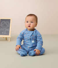 Baby sitting up wearing ergoPouch Long Sleeve Romper 1.0 TOG in Petit Pretzel