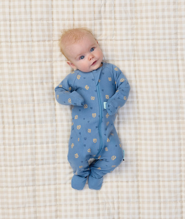 Newborn baby wearing ergoPouch Long Sleeve Romper 1.0 TOG in Petit Pretzel