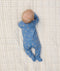 Newborn baby on his stomach in ergoPouch Long Sleeve Romper 1.0 TOG in Petit Pretzel