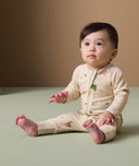 Infant in ergoPouch Long Sleeve Romper 1.0 TOG Savannah, sitting on the floor