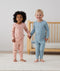 Two toddlers wearing an ergoPouch Long Sleeve Pajamas Dragonflies, holding hands