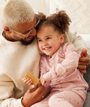 Parent holding child in elong-sleeve-pajamas-0-2-tog-daisies