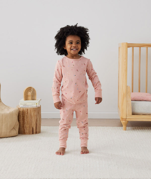 Toddler wearing an ergoPouch Long Sleeve Pajamas 0.2 TOG Daisies