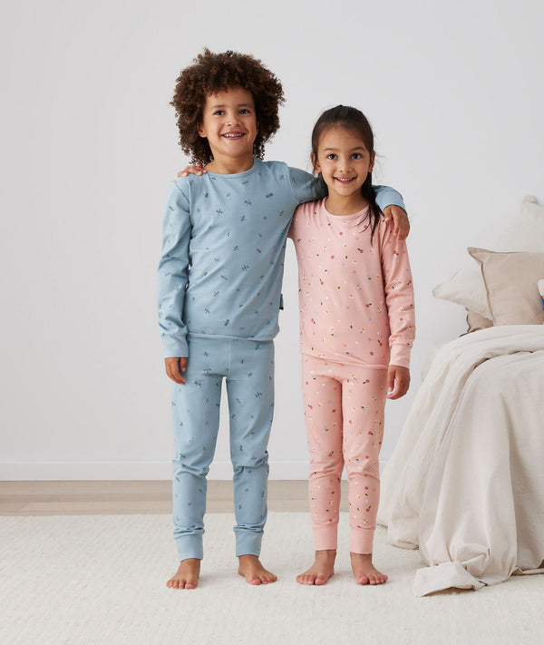 Two children embracing wearing ergoPouch Long Sleeve Pajamas 2.0 TOG Dragonflies, TOG rated pajamas for extra warmth