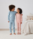 Two kids embracing in long-sleeve-pajamas-1-0-tog-daisies and Dragonflies