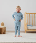 Toddler wearing an ergoPouch Long Sleeve Pajamas 2.0 TOG Dragonflies, hands on hips