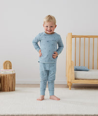 Toddler wearing an ergoPouch Long Sleeve Pajamas 2.0 TOG Dragonflies, hands on hips