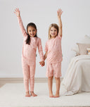 Two kids embracing in long-sleeve-pajamas-0-2-tog-daisies