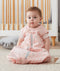 Infant wearing a pink premium sleep sack featuring a front zipper.