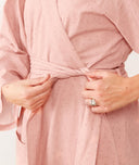 Close up of a woman tightening the robe of an ergoPouch Matchy Matchy Robe Berries
