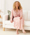 Woman smiling wearing an ergoPouch Matchy Matchy Robe Daisies
