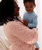 Mom wearing a an ergoPouch Matchy Matchy Robe Daisies, holding a child