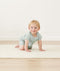 Infant crawling wearing a ergoPouch Short Sleeve Romper in Sage