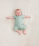 Baby lying wearing a ergoPouch Short Sleeve Romper in Sage