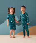 Two toddler holding hands in ergoPouch Short Sleeve Pajamas 0.2 TOG Ocean Blue, perfect for the summer