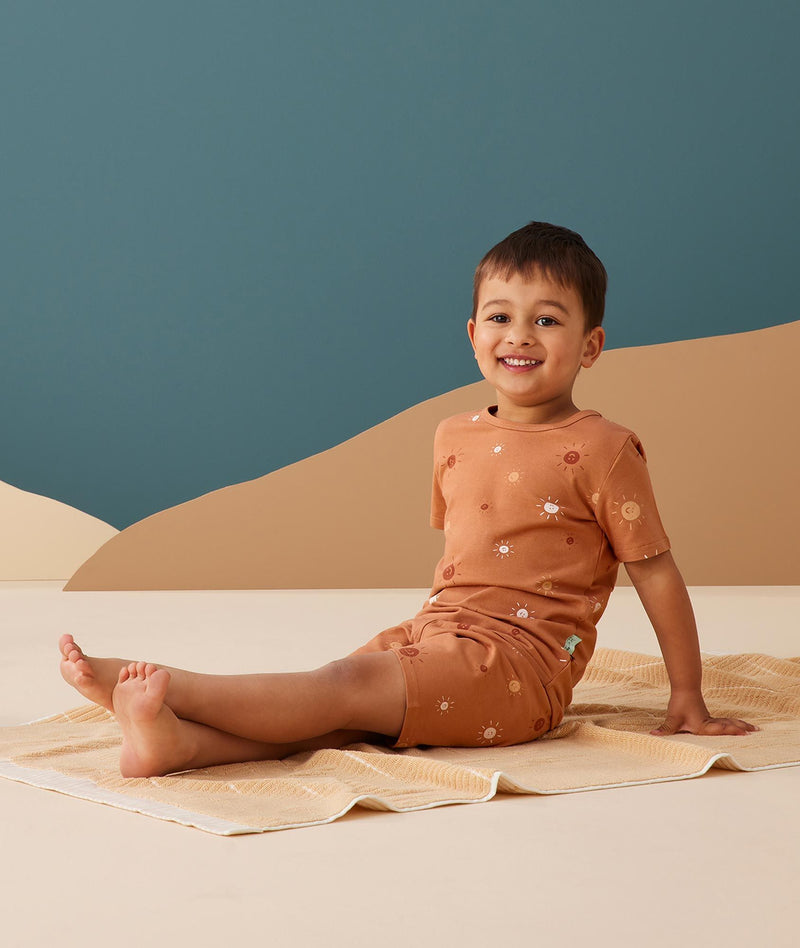 Preschooler wearing ergoPouch Short Sleeve Pajamas 0.2 TOG Sunny