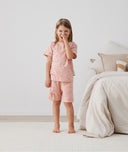 Toddler standing in ergoPouch Short Sleeve Pajamas 0.2 TOG Daisies, perfect for the summer