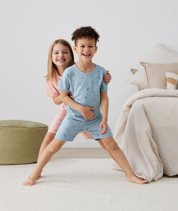 Two toddler standing in ergoPouch Short Sleeve Pajamas 0.2 TOG Dragonflies, perfect for the summer