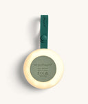 Back view of the portable white noise machine, shown with a glowing light and displays model details and certification symbols.