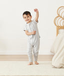 Toddler standing in ergoPouch Sleep Onesie 1.0 TOG Grey Marle