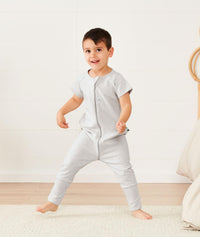 Toddler standing in ergoPouch Sleep Onesie 1.0 TOG Grey Marle