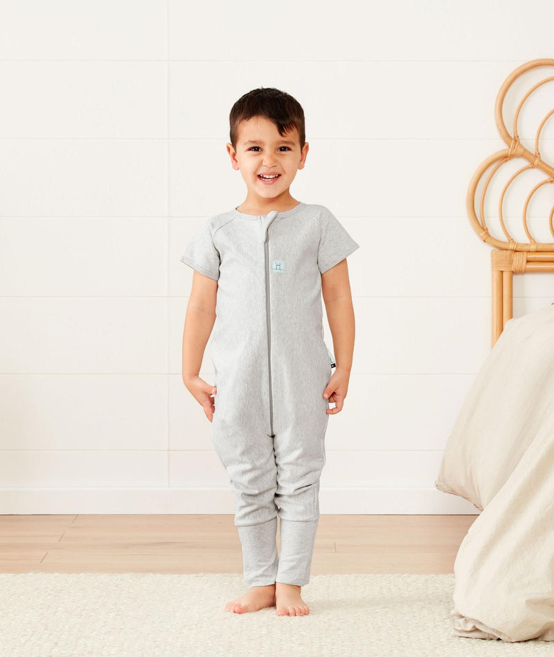 Preschooler standing, wearing an ergoPouch Sleep Onesie 1.0 TOG Grey Marle