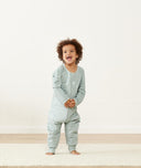 Toddler laughing in ergoPouch Sleep Onesie in Sage