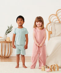 Toddlers wearing ergoPouch Short Sleeve Pajamas in Sage and ergoPouch Sleep Suit Bag in Berries