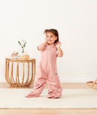 Child standing in ergoPouch Sleep Suit Sack 1.0 TOG Berries, a sleeping bag that converts to a sleeping bag with legs