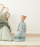 Toddler wearing ergoPouch Sleep Suit Sack in Sage