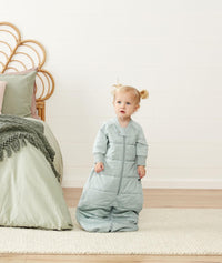 Toddler wearing ergoPouch Sleep Suit Sack in Sage