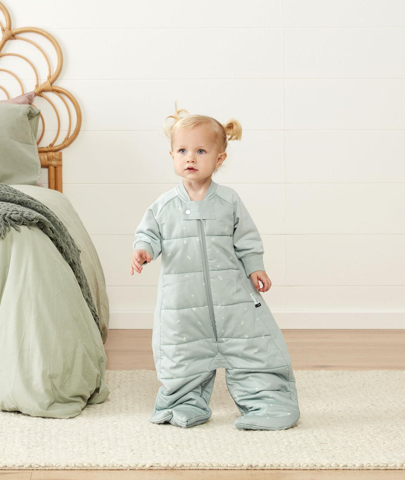 Smiling child in ergoPouch Sleep Suit Sack 3.5 TOG Sage, a warm sleep sack with legs