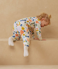 Child playing in ergoPouch Sleep Onesie 2.5 TOG Fruit Salad, warm for the winter