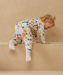 Child playing in ergoPouch Sleep Onesie 3.5 TOG Fruit Salad, warm for the winter