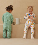 Two children playing in ergoPouch Sleep Onesie 2.5 TOG Sweet Orchard and Fruit Salad, warm pouch for the winter