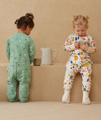 Two children playing in ergoPouch Sleep Onesie 3.5 TOG Fruit Salad and Sweet Orchard, warm pouch for the winter