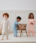 Three children playing wearing ergoPouch Sleep Onesie 3.5 TOG Dragonflies, Daisies, and Oatmeal Marle