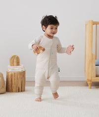 Child playing in ergoPouch Sleep Onesie 2.5 TOG Oatmeal Marle, warm for the winter