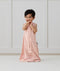 Child standing in ergoPouch Jersey Sleep Suit Sack 0.2 TOG Daisies, a light sleeping bag that converts to a sleeping bag with legs