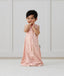 Child standing in ergoPouch Jersey Sleep Suit Sack 0.2 TOG Daisies, a light sleeping bag that converts to a sleeping bag with legs