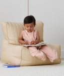 Child playing in ergoPouch Jersey Sleep Suit Sack 0.2 TOG Daisies, a light sleeping bag that converts to a sleeping bag with legs