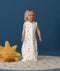 Smiling toddler wearing an ergoPouch Jersey Sleep Suit Sack  0.2 TOG Daydream, a sleeping sack that converts to a sleep suit with legs