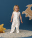Smiling toddler wearing an ergoPouch Jersey Sleep Suit Sack  0.2 TOG Daydream, a sleeping sack that converts to a sleep suit with legs