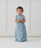 Child standing in ergoPouch Jersey Sleep Suit Sack 0.2 TOG Dragonflies, a light sleeping bag that converts to a sleeping bag with legs