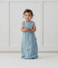 Child standing in ergoPouch Jersey Sleep Suit Sack 0.2 TOG Dragonflies, a light sleeping bag that converts to a sleeping bag with legs