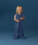 Smiling toddler wearing an ergoPouch Jersey Sleep Suit Sack 0.2 TOG Starbeam, a sleep sack that converts to a sleep suit with legs.