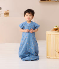 Toddler standing wearing ergoPouch Sleep Suit Sack 1.0 TOG in Petit Pretzel