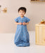 Toddler standing wearing ergoPouch Sleep Suit Sack 1.0 TOG in Petit Pretzel
