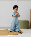 Toddler wearing an ergoPouch Sleep Suit Sack 1.0 TOG Dragonflies