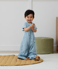 Toddler wearing an ergoPouch Sleep Suit Sack 1.0 TOG Dragonflies